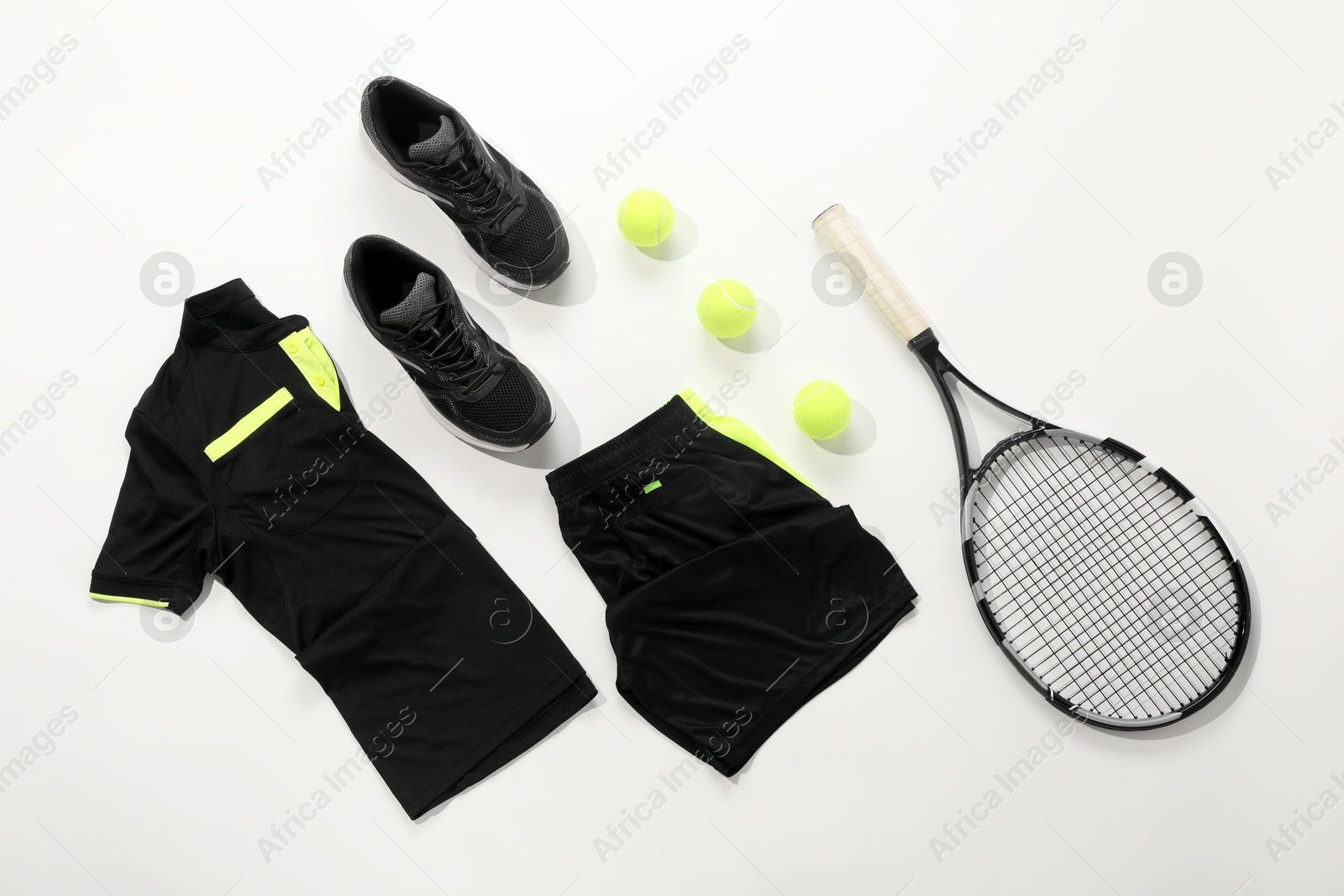 Photo of Tennis racket, balls and sportswear on white background, flat lay