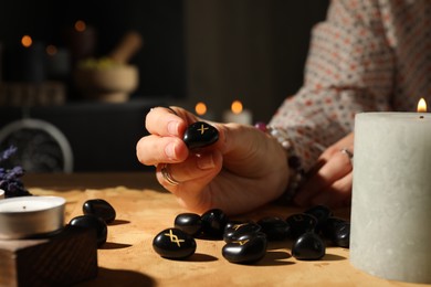 Photo of Woman with rune Gebo at table indoors, closeup