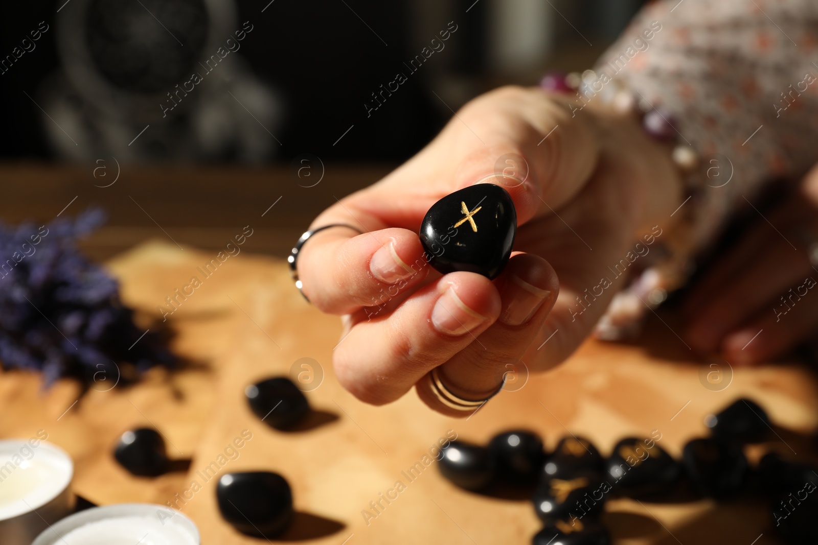 Photo of Woman with rune Gebo at table, closeup