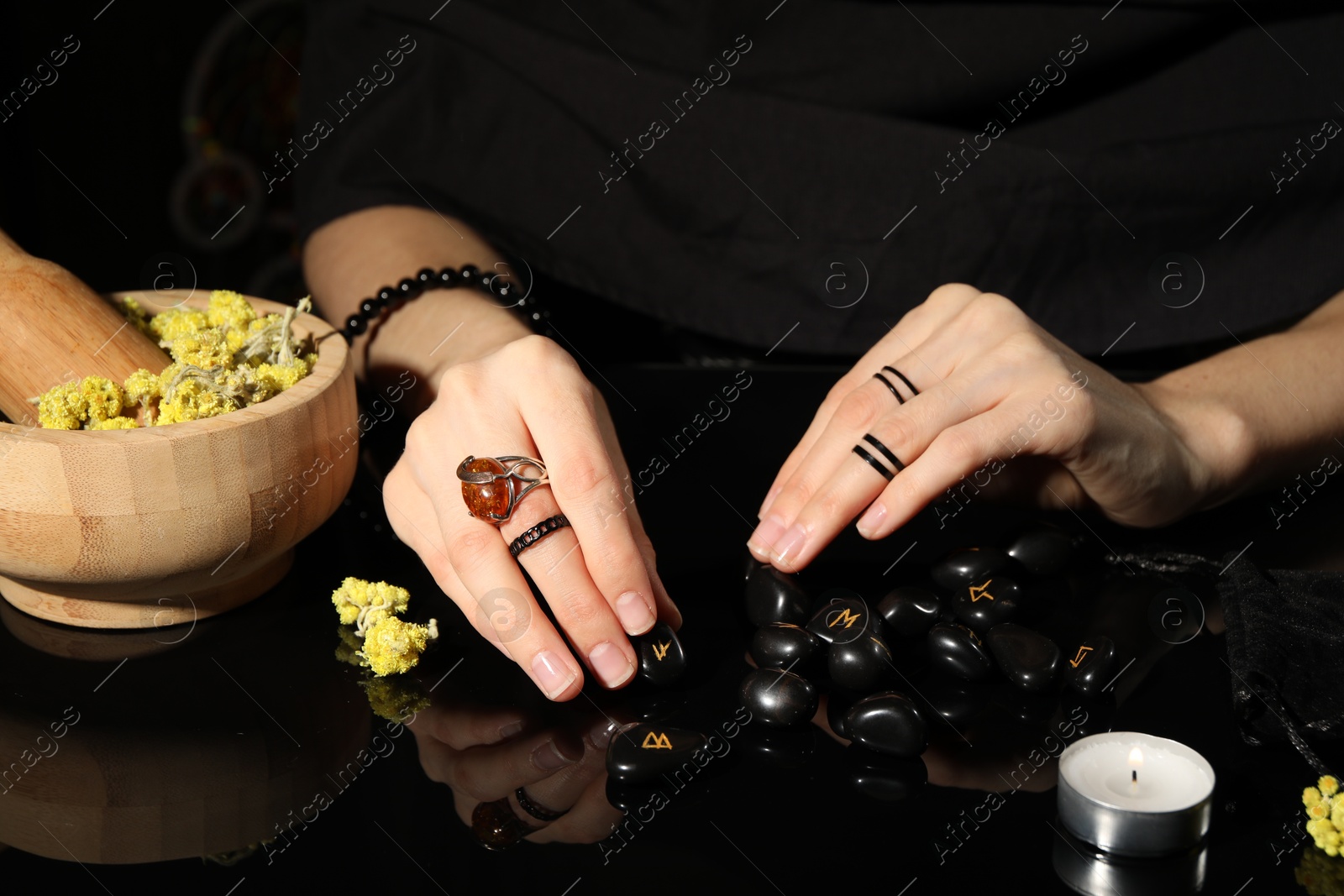 Photo of Woman with black runes at table, closeup