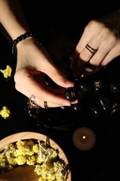 Photo of Woman with black rune Hagalaz at table, top view