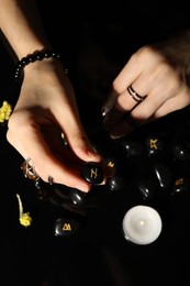 Photo of Woman with black rune Hagalaz at table, top view