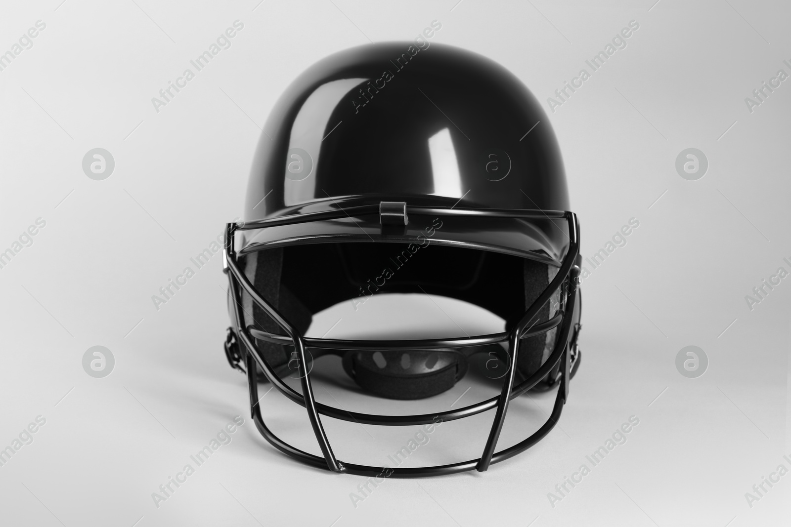 Photo of One black baseball helmet on white background