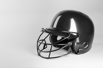 One black baseball helmet on white background, space for text