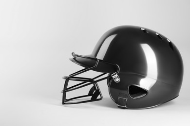 Photo of One black baseball helmet on white background