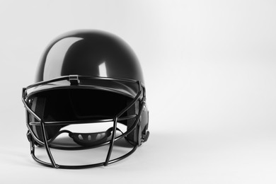 One black baseball helmet on white background, space for text