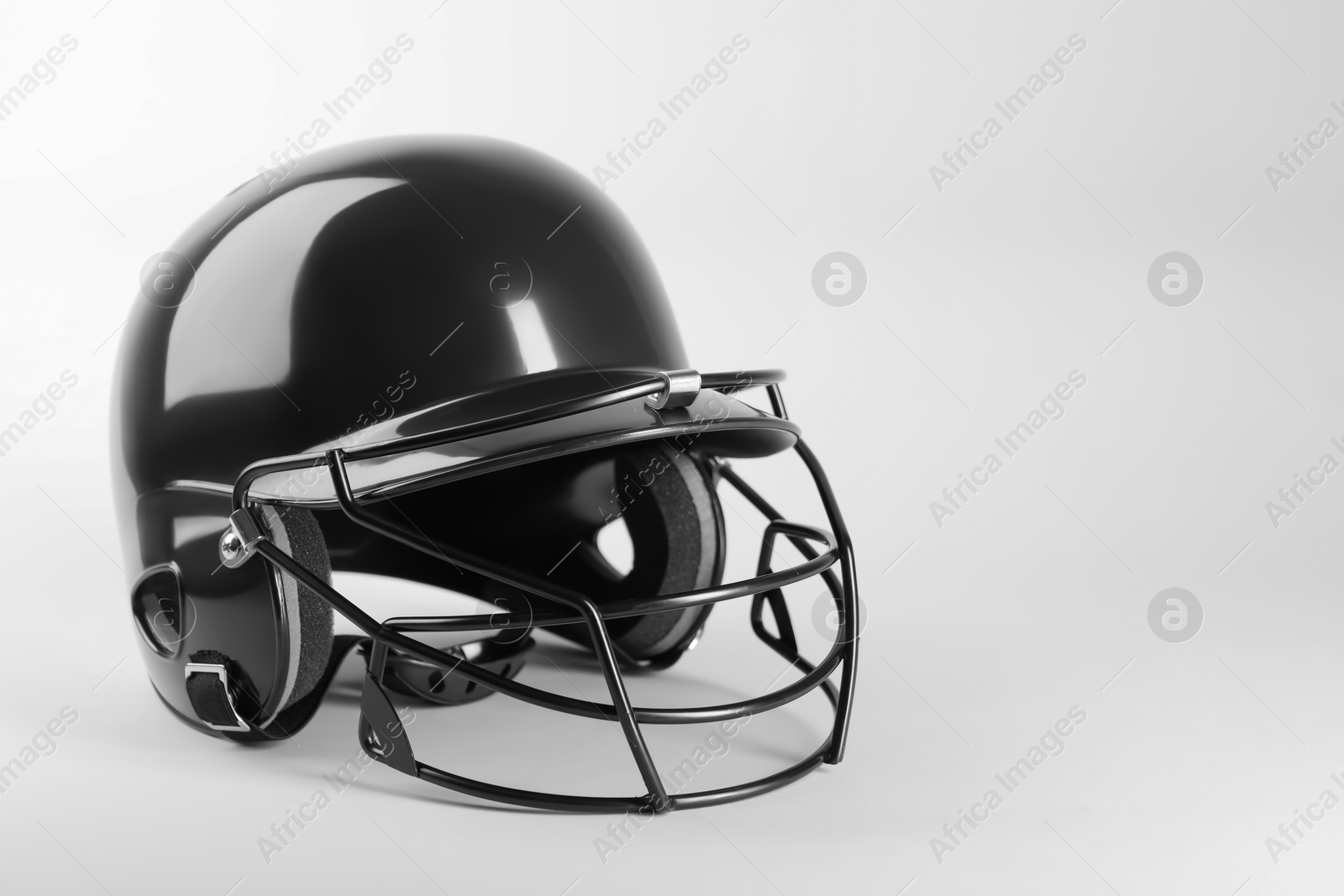 Photo of One black baseball helmet on white background, space for text