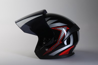 Photo of Motorcycle helmet with visor on light grey background