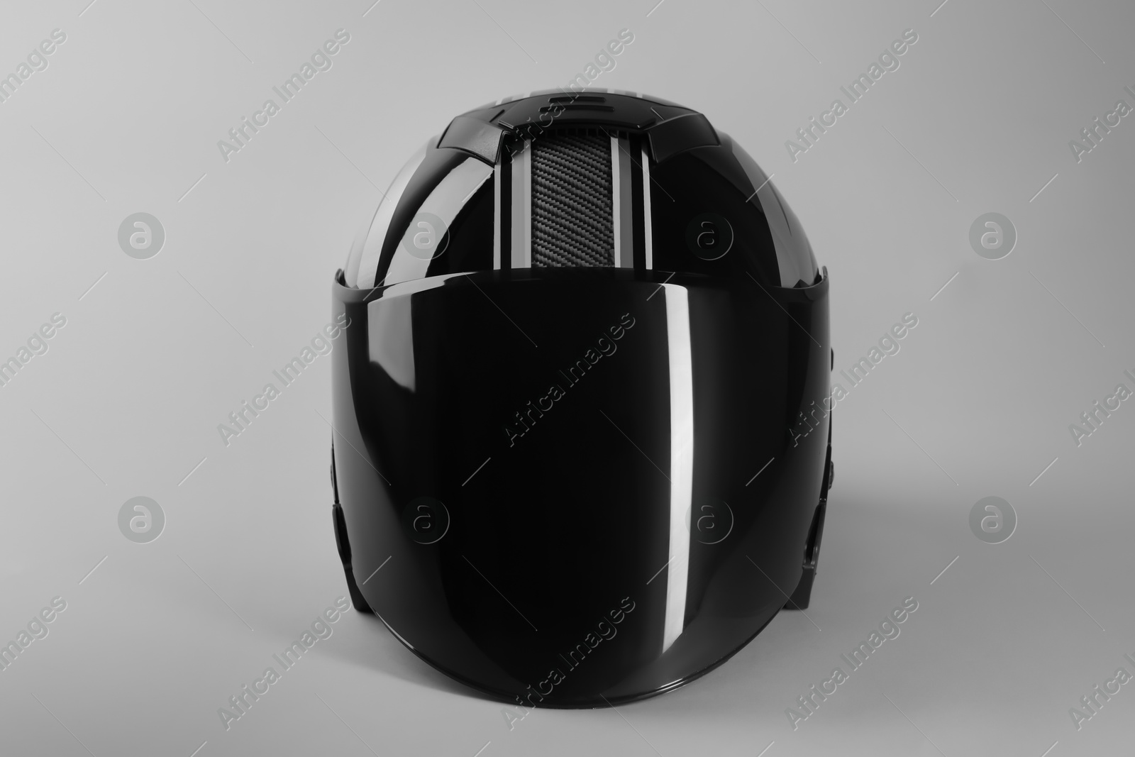 Photo of Motorcycle helmet with visor on light grey background