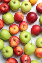 Many fresh apples on white background, flat lay