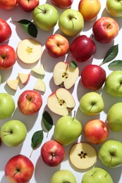 Flat lay composition with whole and cut apples on white background