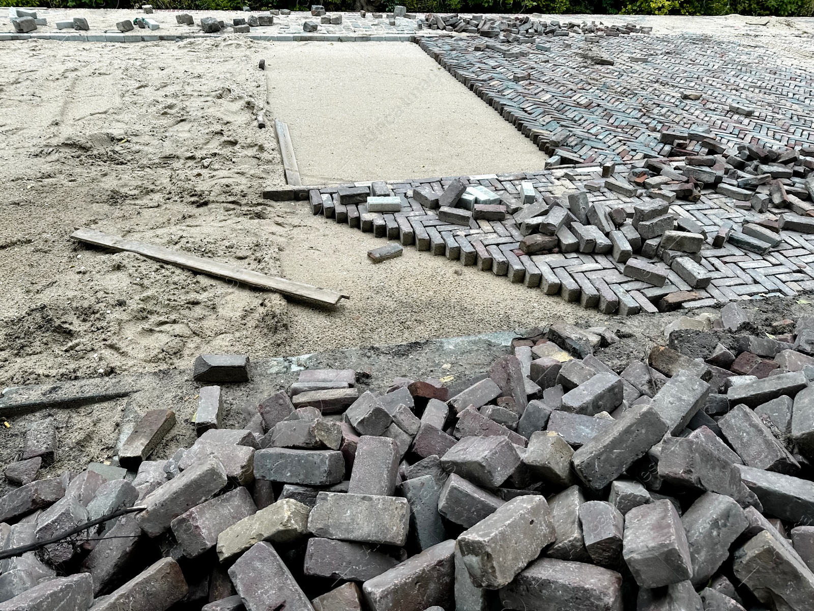 Photo of Process of laying paving stone blocks outdoors