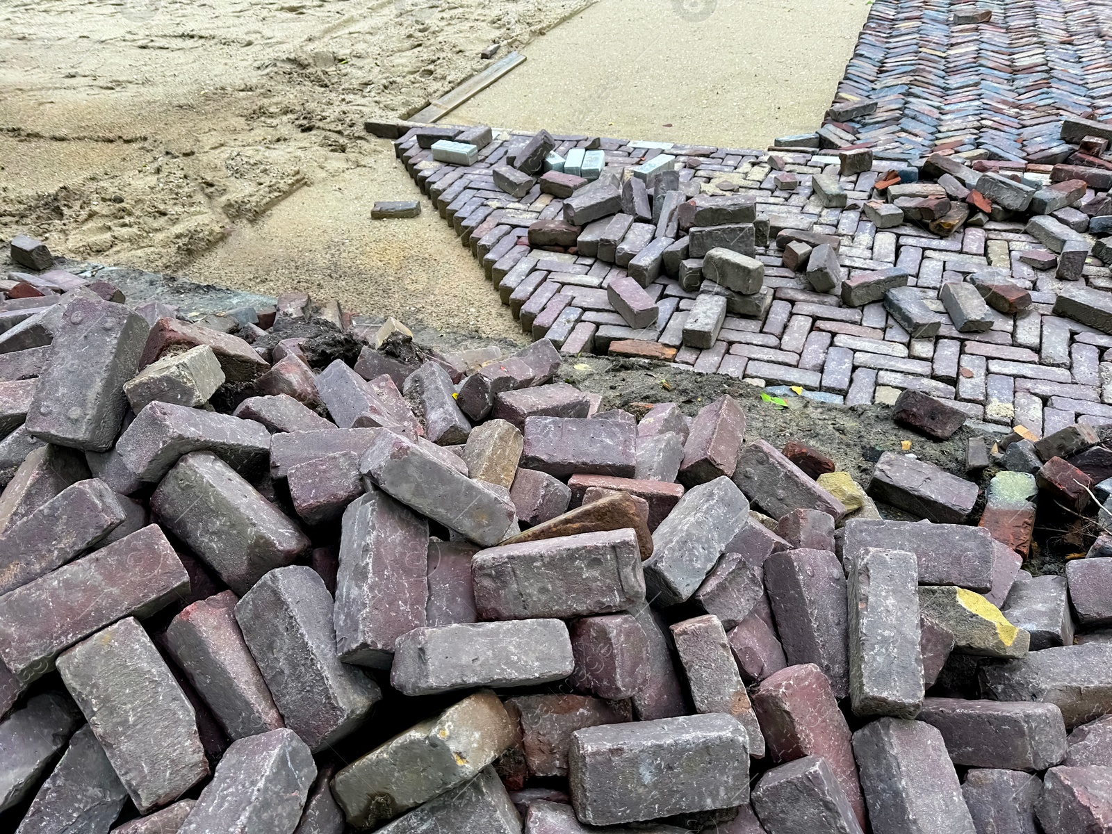 Photo of Process of laying paving stone blocks outdoors