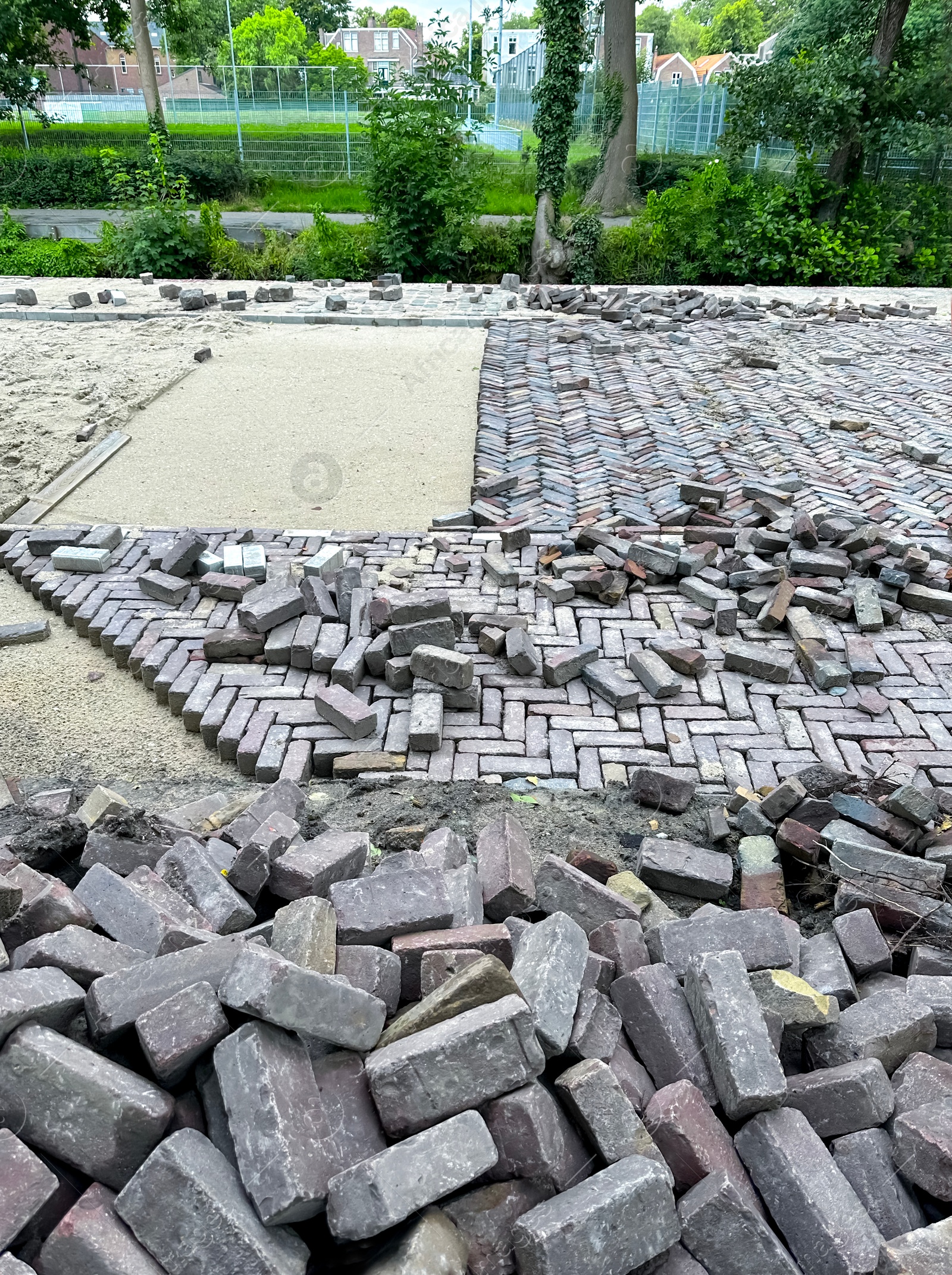 Photo of Process of laying paving stone blocks outdoors