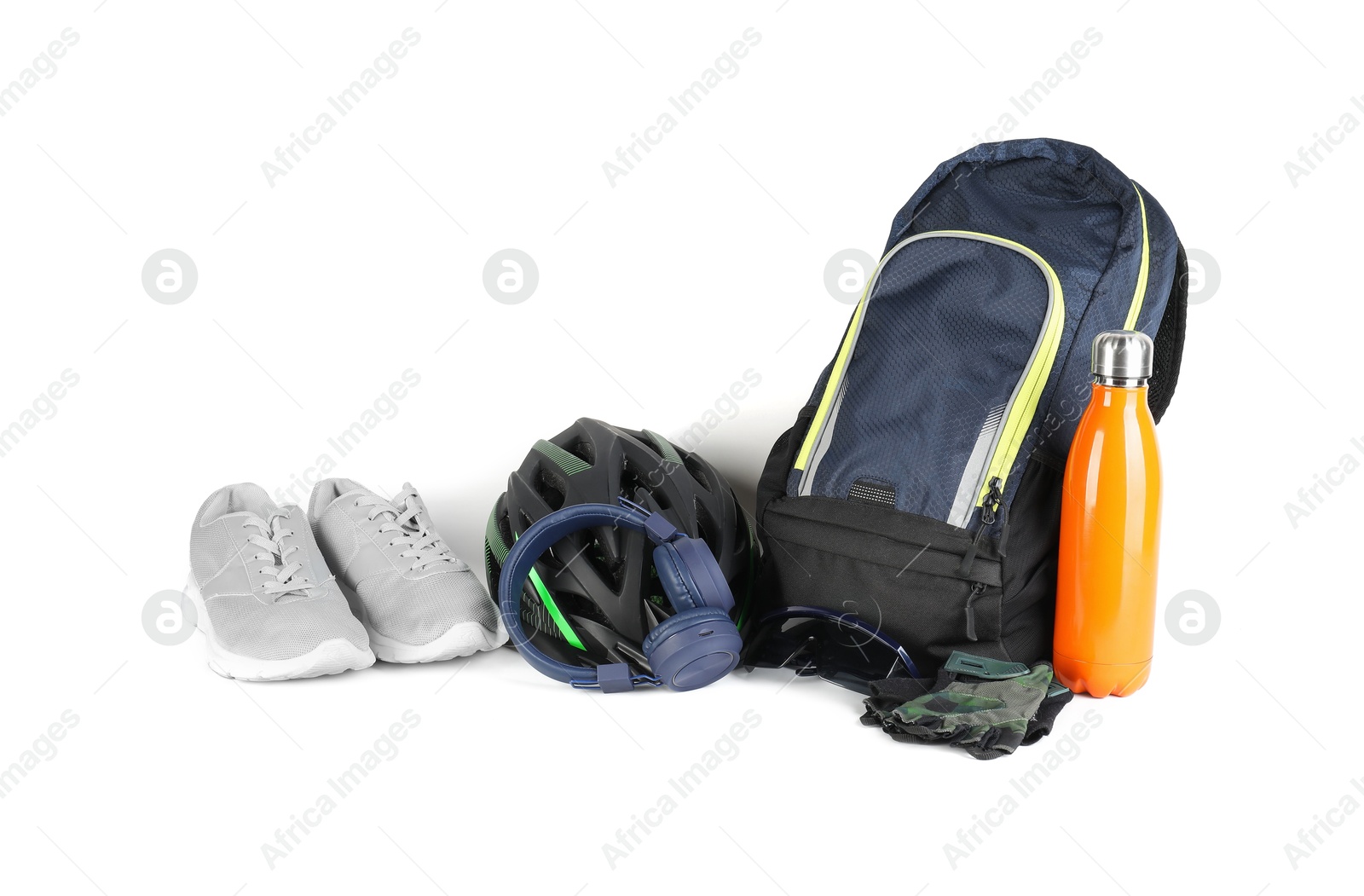 Photo of Bicycle helmet, accessories, thermo bottle, sneakers and headphones on white background