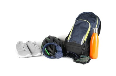 Bicycle helmet, accessories, thermo bottle, sneakers and headphones on white background