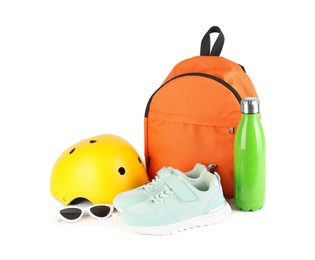 Bicycle helmet, thermo bottle, sneakers, sunglasses and backpack isolated on white