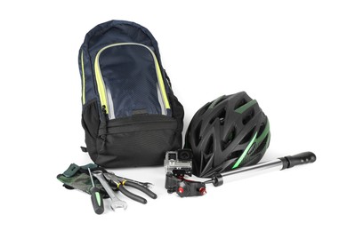 Photo of Bicycle helmet, backpack, fingerless gloves, action camera and tools isolated on white