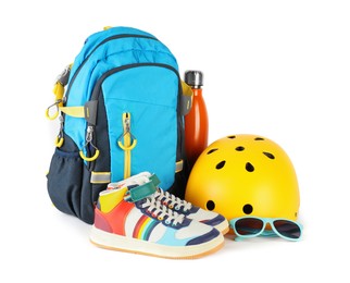 Bicycle helmet, thermo bottle, sneakers, sunglasses and backpack isolated on white