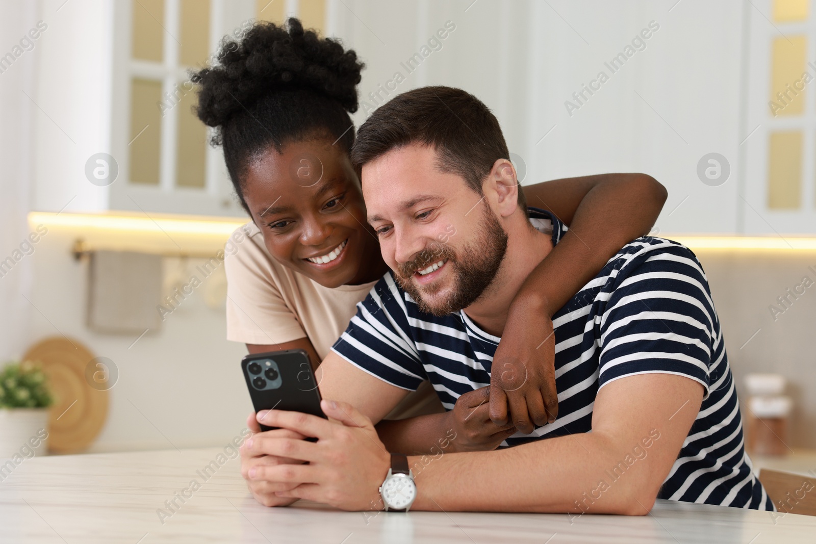 Photo of International relationships. Lovely couple spending time together in kitchen