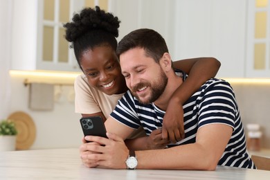 International relationships. Lovely couple spending time together in kitchen