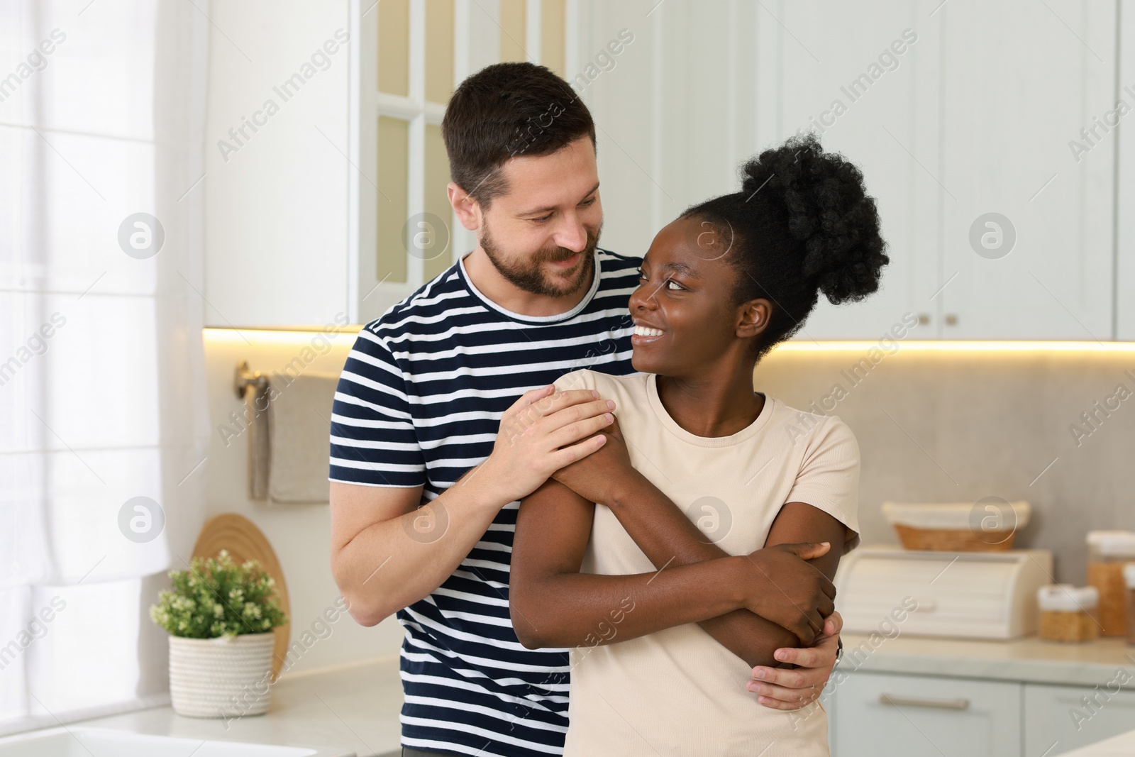 Photo of International relationships. Portrait of lovely couple in kitchen