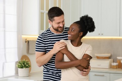 International relationships. Portrait of lovely couple in kitchen