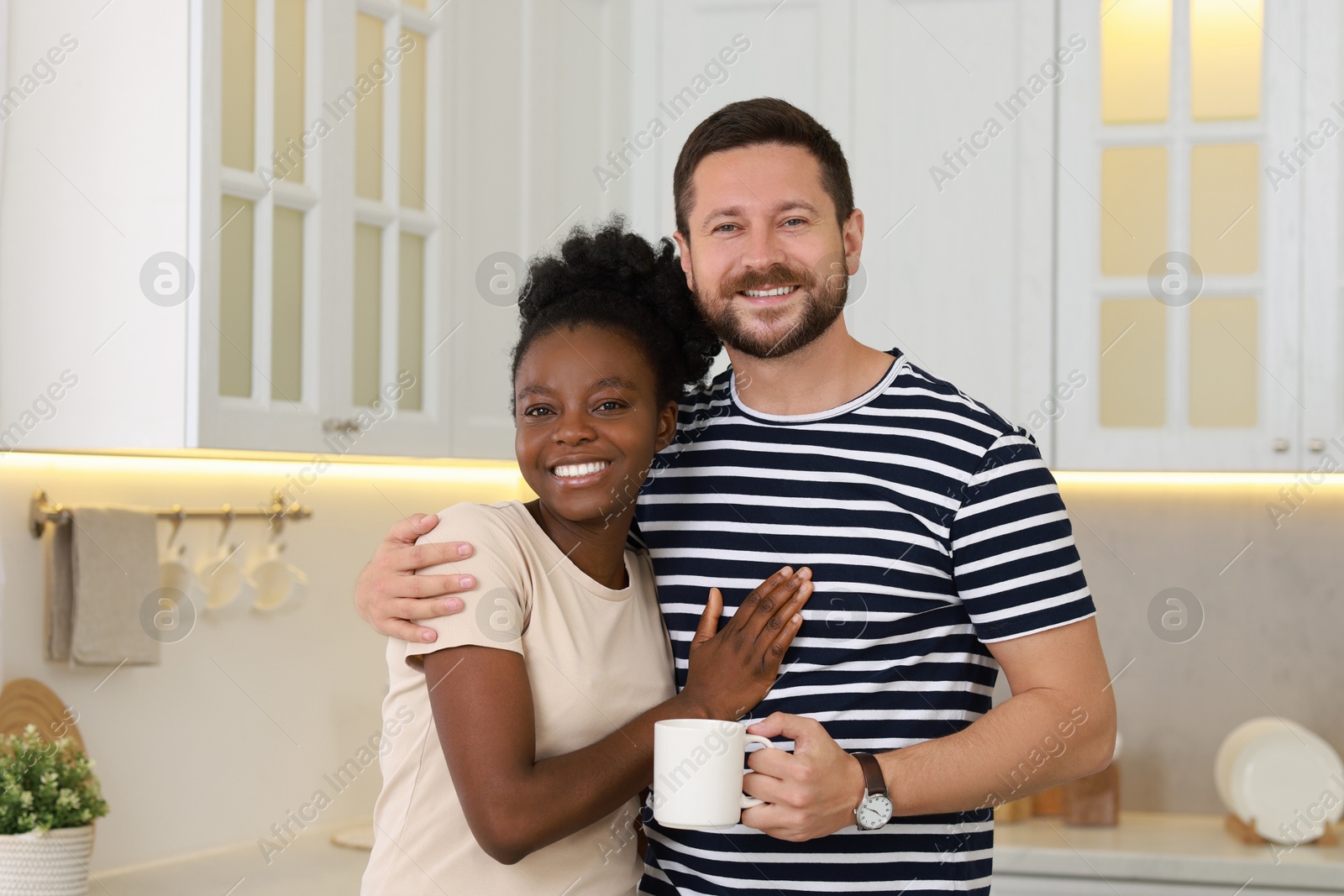 Photo of International relationships. Portrait of lovely couple in kitchen