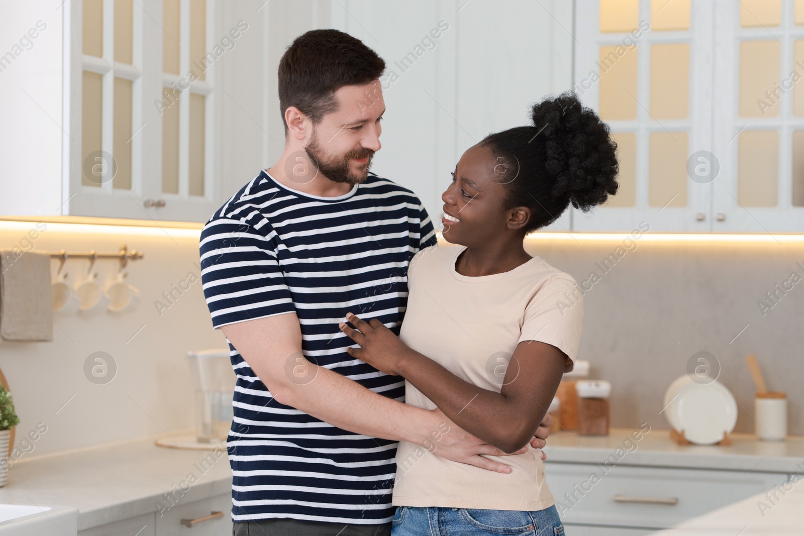 Photo of International relationships. Portrait of lovely couple in kitchen