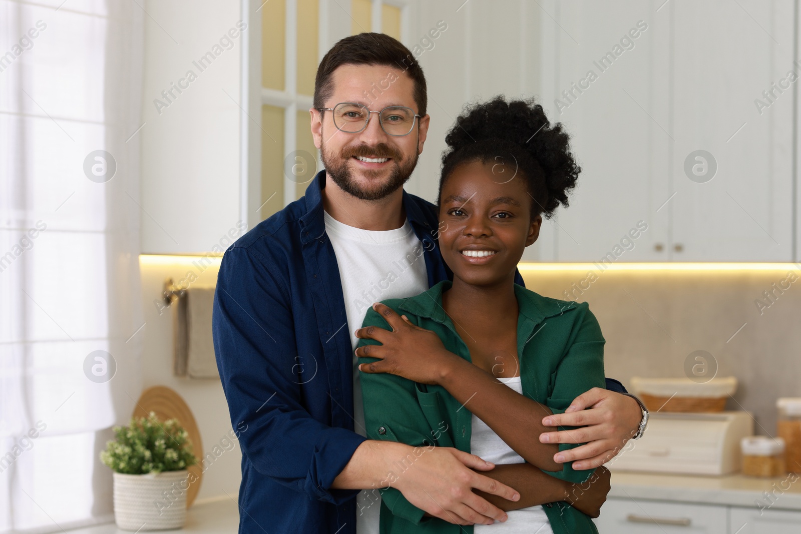 Photo of International relationships. Portrait of lovely couple in kitchen