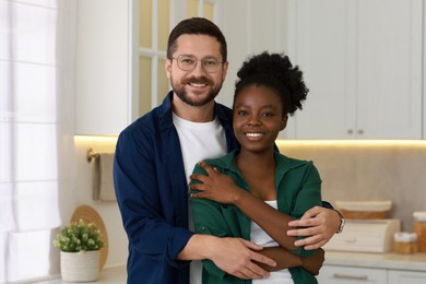 Photo of International relationships. Portrait of lovely couple in kitchen