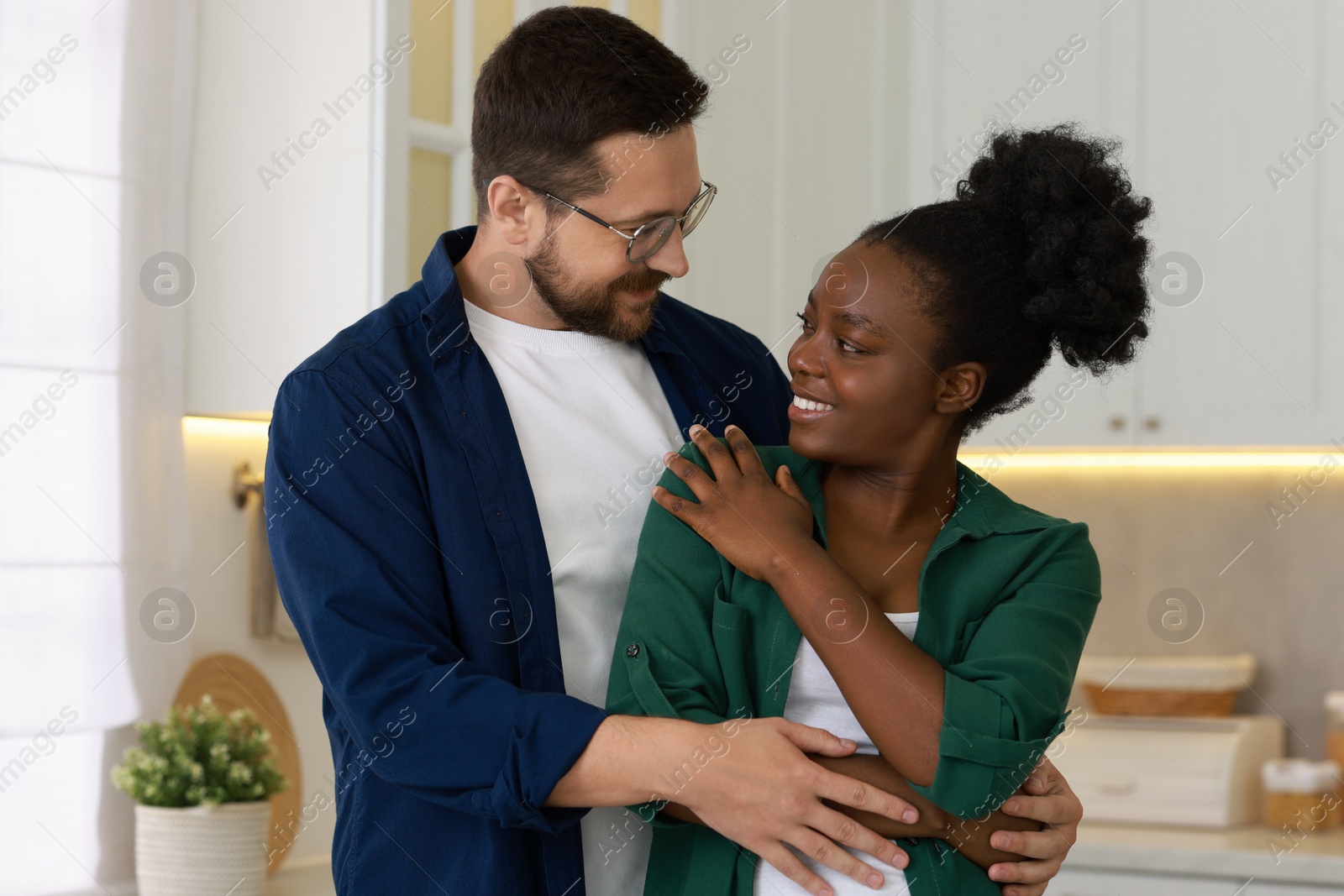 Photo of International relationships. Portrait of lovely couple in kitchen