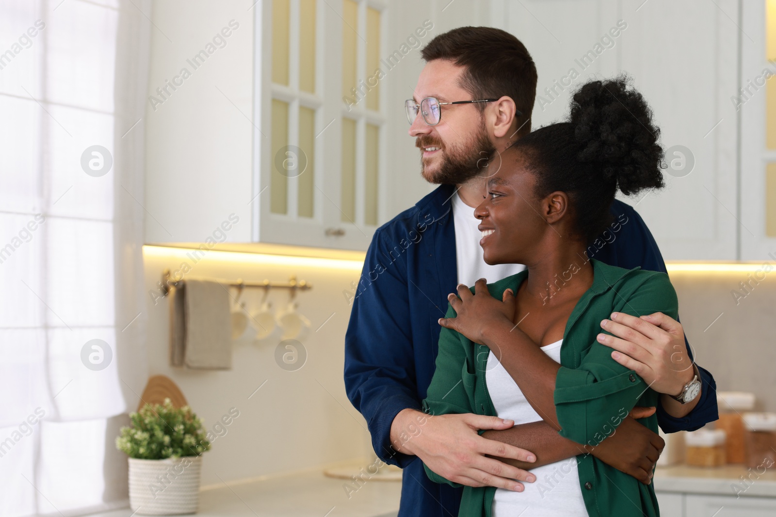 Photo of International relationships. Portrait of lovely couple in kitchen