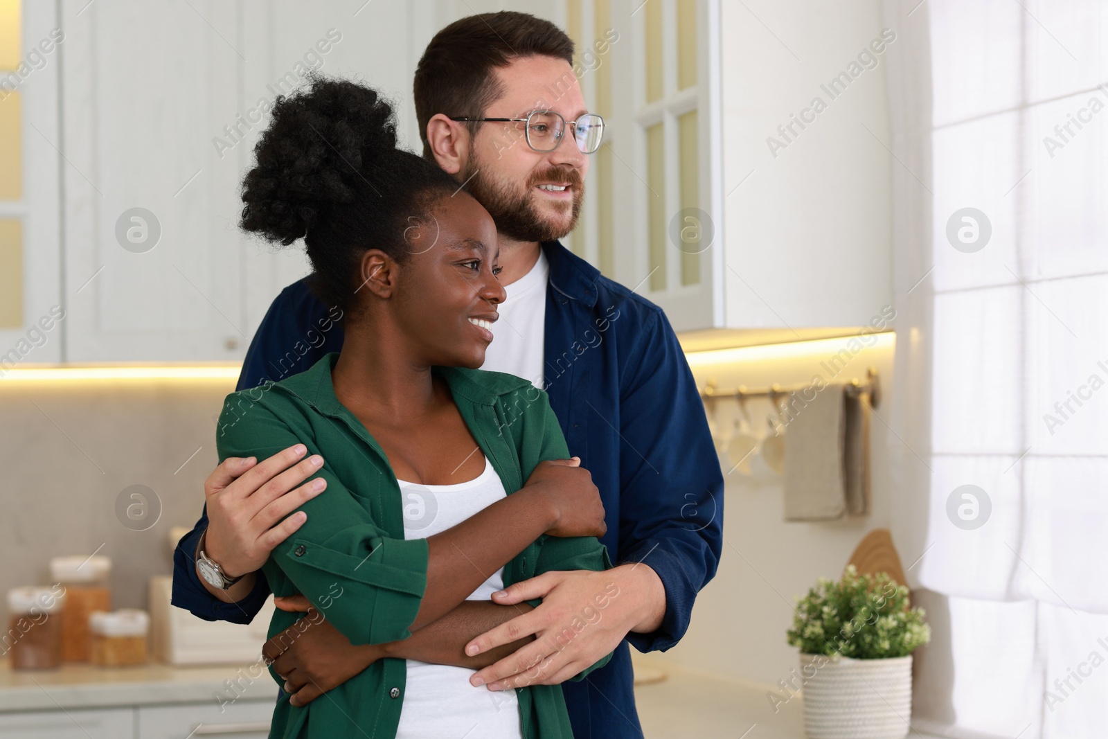 Photo of International relationships. Portrait of lovely couple in kitchen