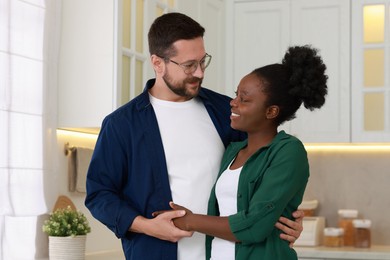 Photo of International relationships. Portrait of lovely couple in kitchen