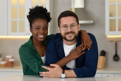 Photo of International relationships. Portrait of lovely couple in kitchen