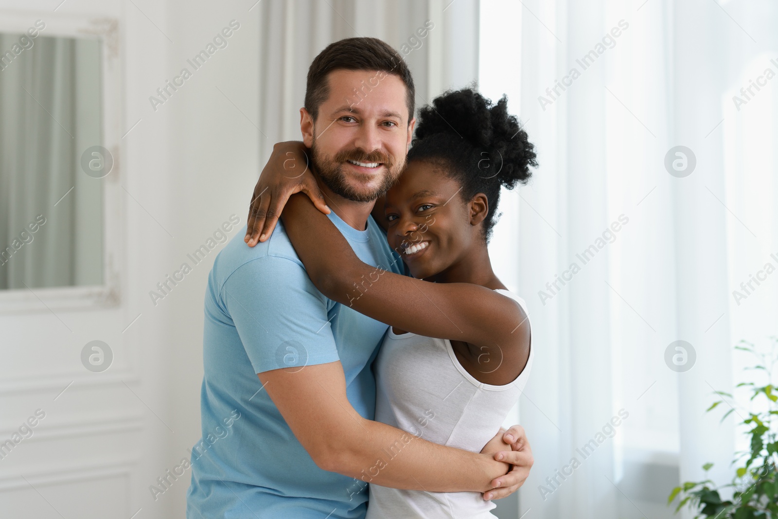 Photo of International relationships. Portrait of lovely couple at home