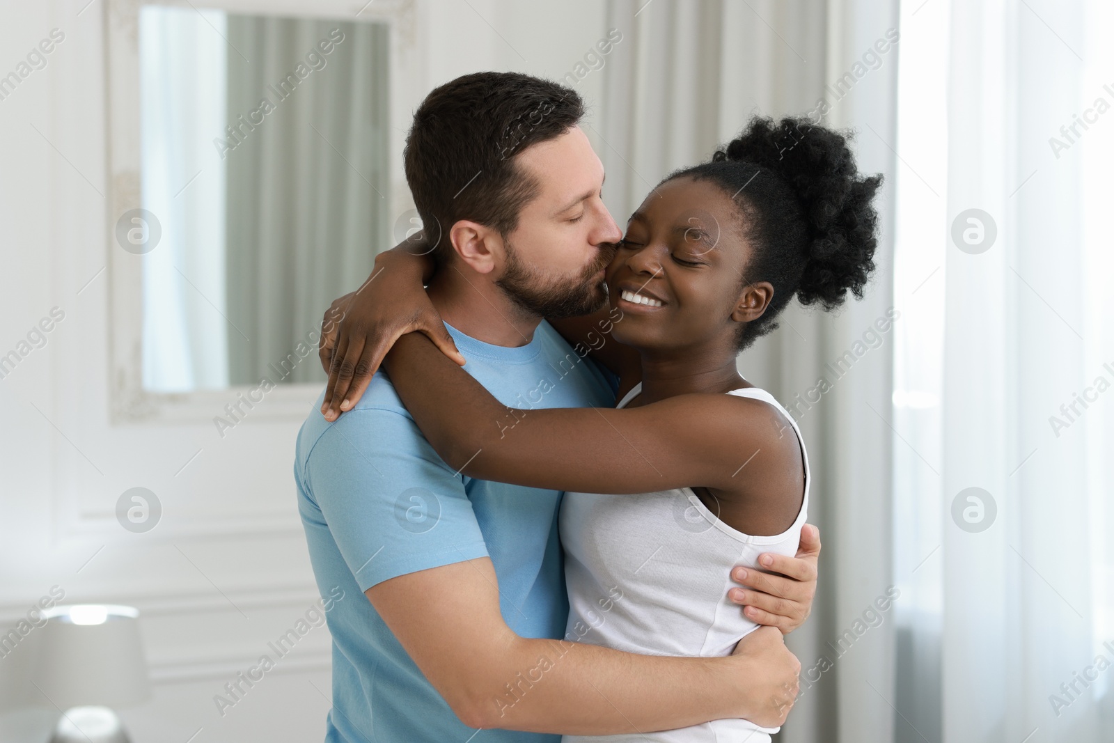 Photo of International relationships. Portrait of lovely couple at home