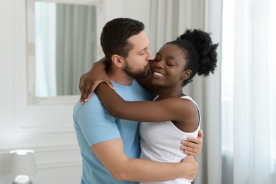 Photo of International relationships. Portrait of lovely couple at home