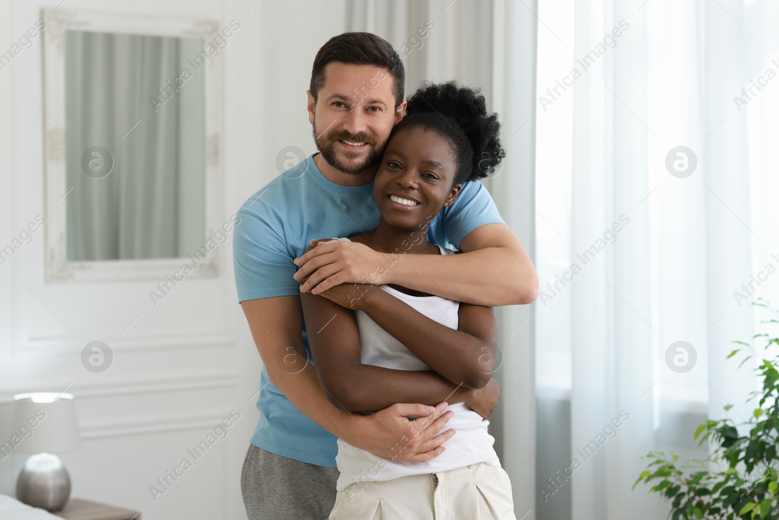 Photo of International relationships. Portrait of lovely couple at home