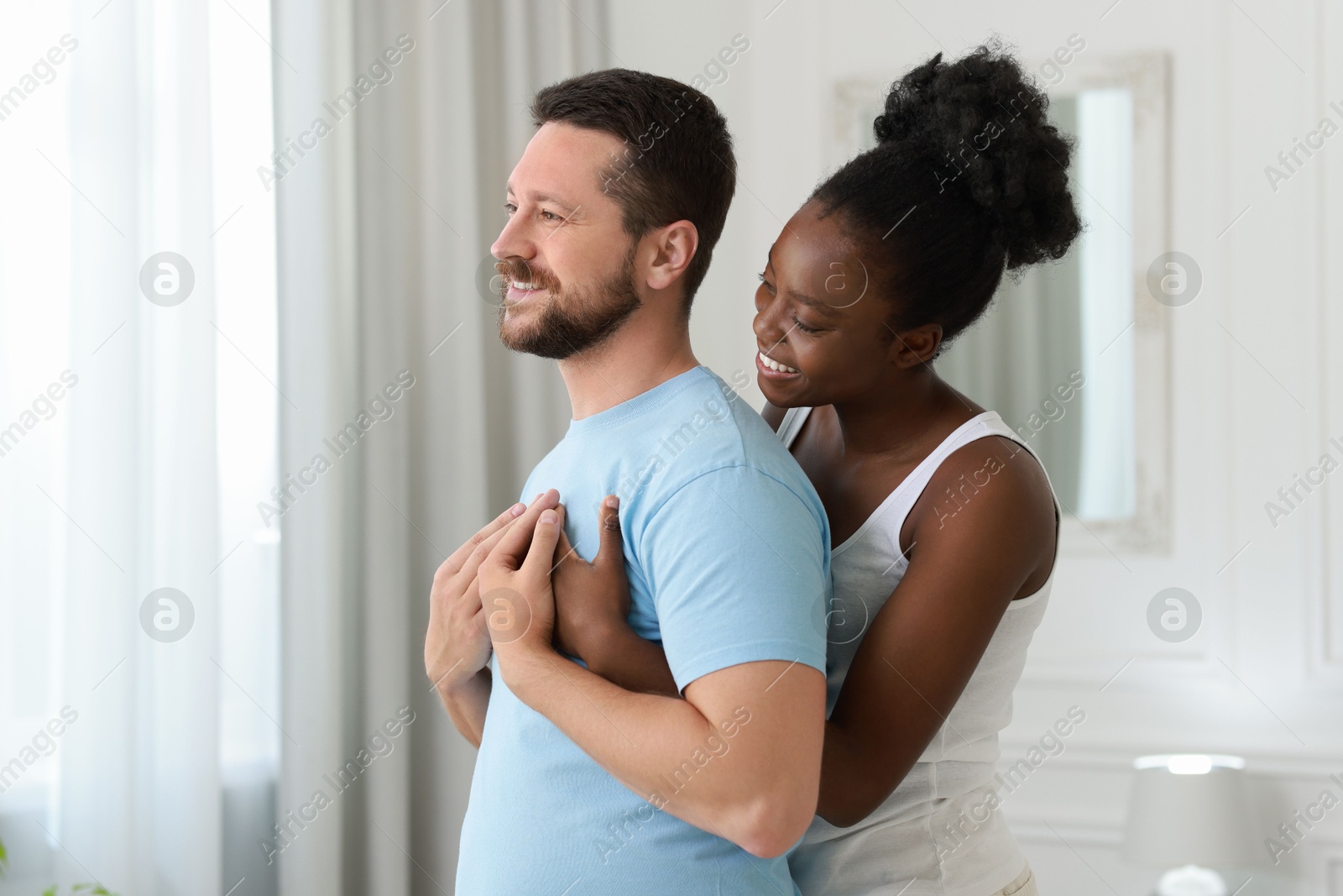 Photo of International relationships. Portrait of lovely couple at home