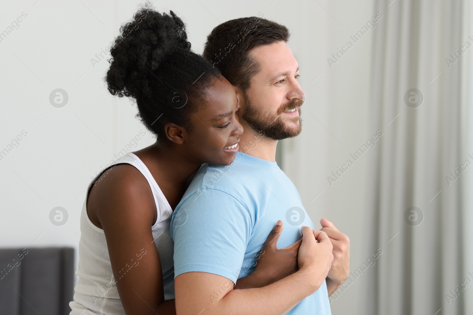 Photo of International relationships. Portrait of lovely couple at home