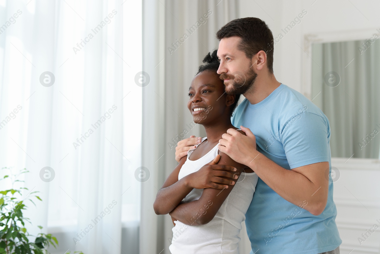 Photo of International relationships. Portrait of lovely couple at home, space for text