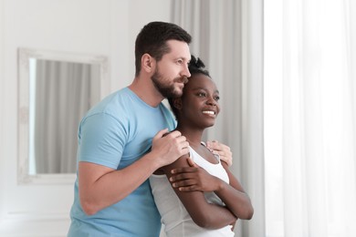 Photo of International relationships. Portrait of lovely couple at home