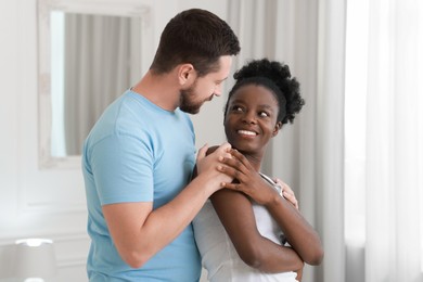 International relationships. Portrait of lovely couple at home