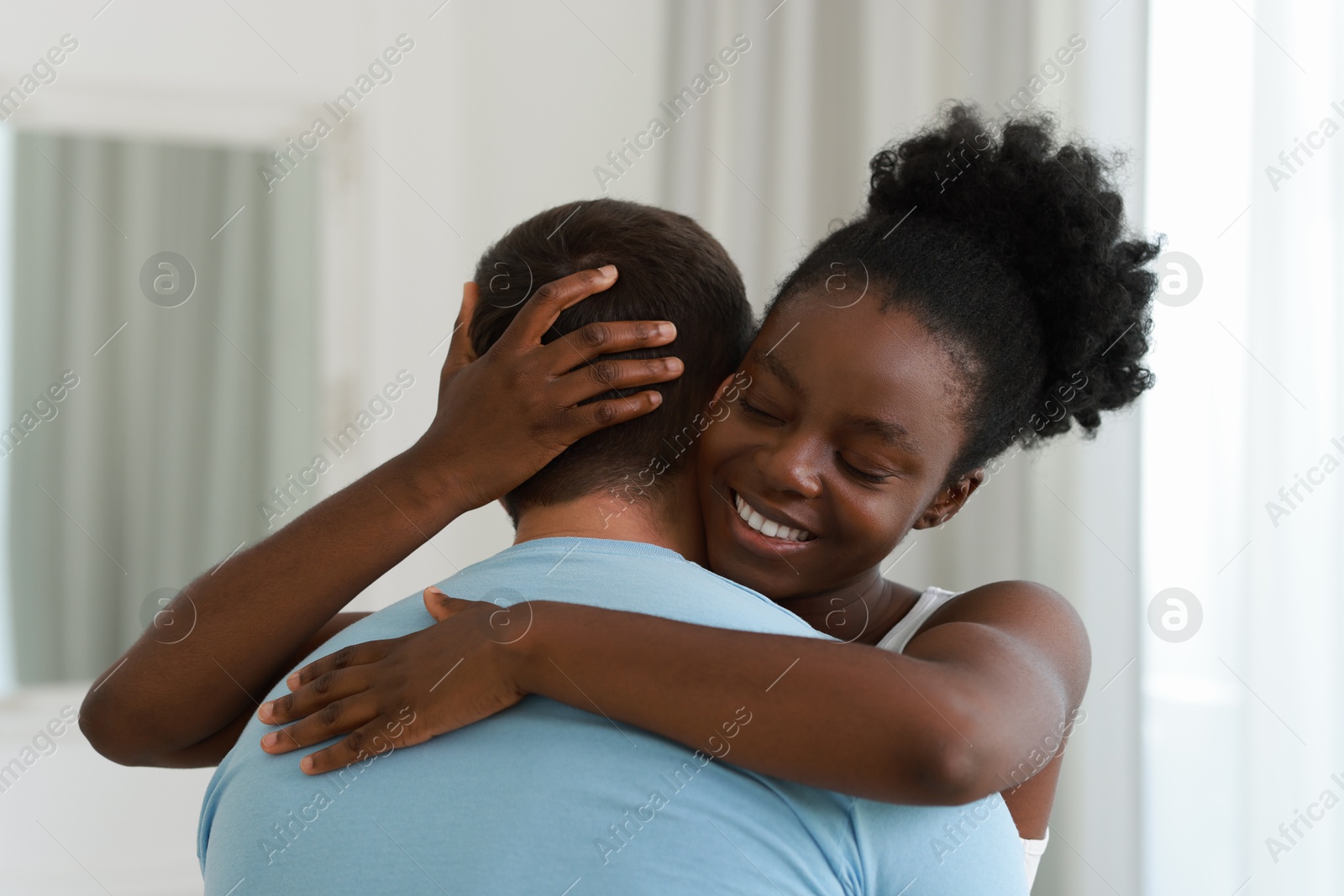 Photo of International relationships. Portrait of lovely couple at home