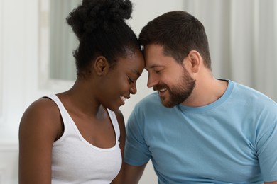 International relationships. Portrait of lovely couple at home