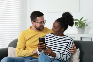 Photo of International relationships. Lovely couple spending time together at home