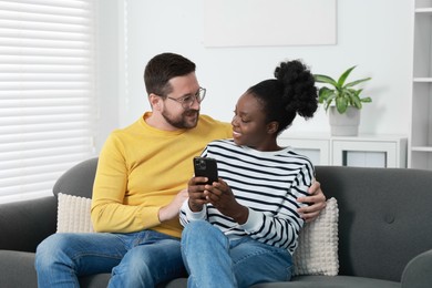 International relationships. Lovely couple spending time together at home