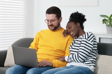 Photo of International relationships. Lovely couple spending time together at home